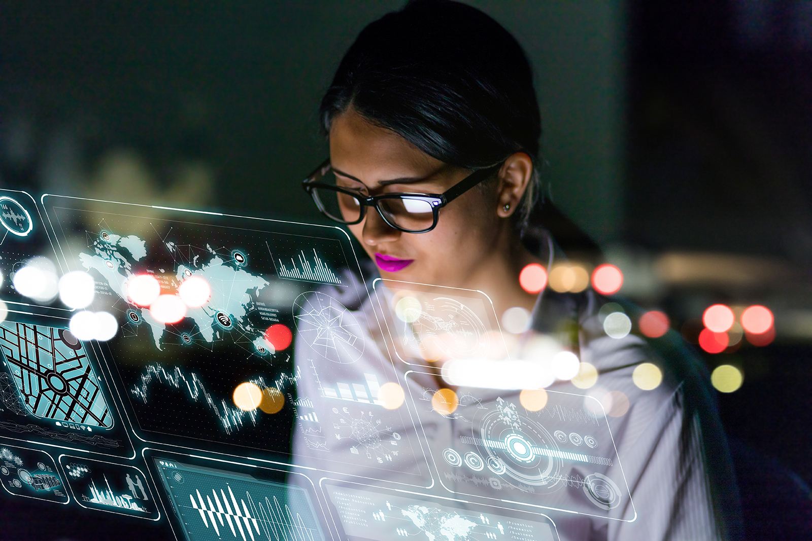 Female engineer looking at a number of interactive screens